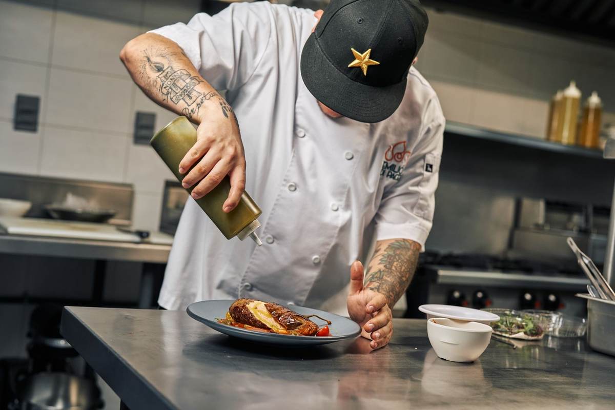 Private chef plating a signature dinner in a Mauritius villa kitchen