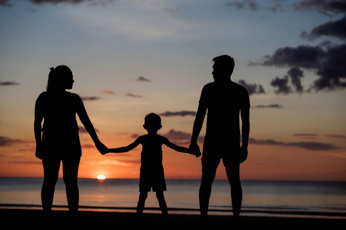 Three generations of a family gathered by the pool of a private villa in Mauritius