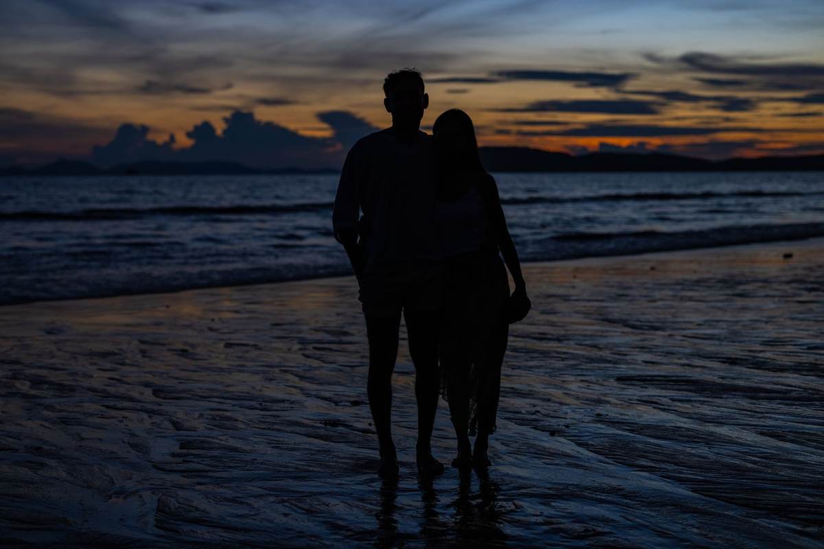 Couple at dusk on a private villa terrace over a Mauritian lagoon
