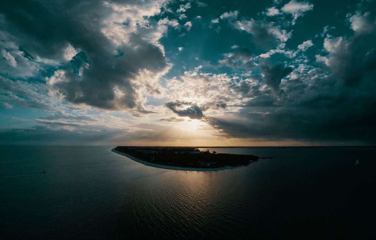 Aerial view of a small islet in the Mauritius lagoon ringed by turquoise water
